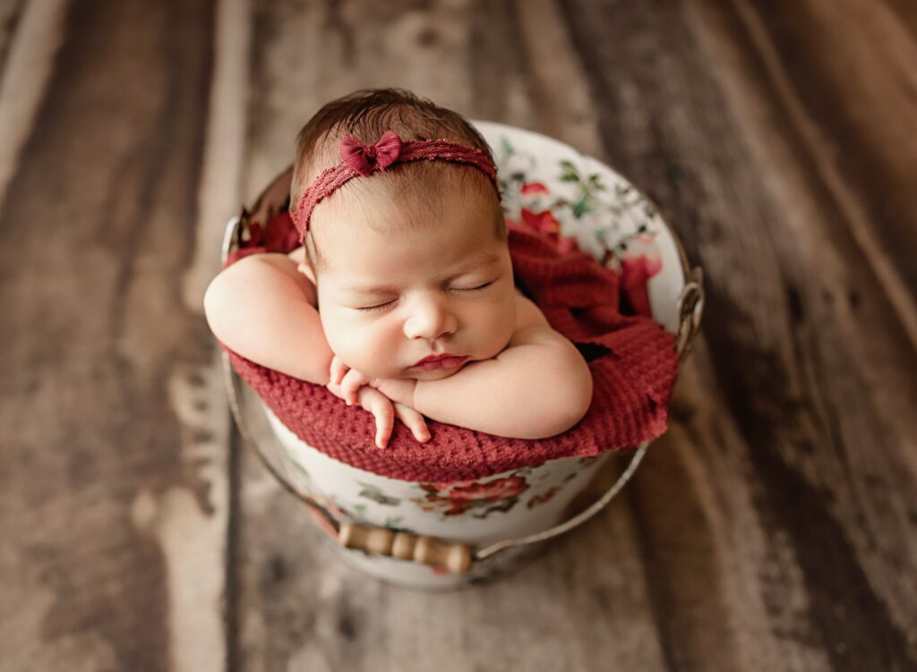 Peaceful newborn sleeping pose with safety spotter nearby
