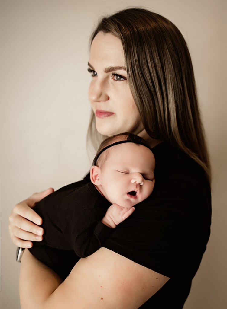 Family cuddles with newborn photographed in Sacramento studio