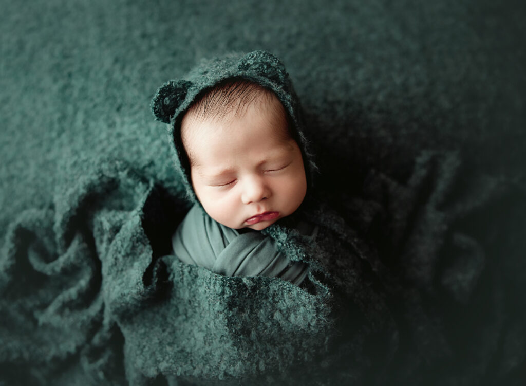 newborn photo session cute wrapped up bear pose. 