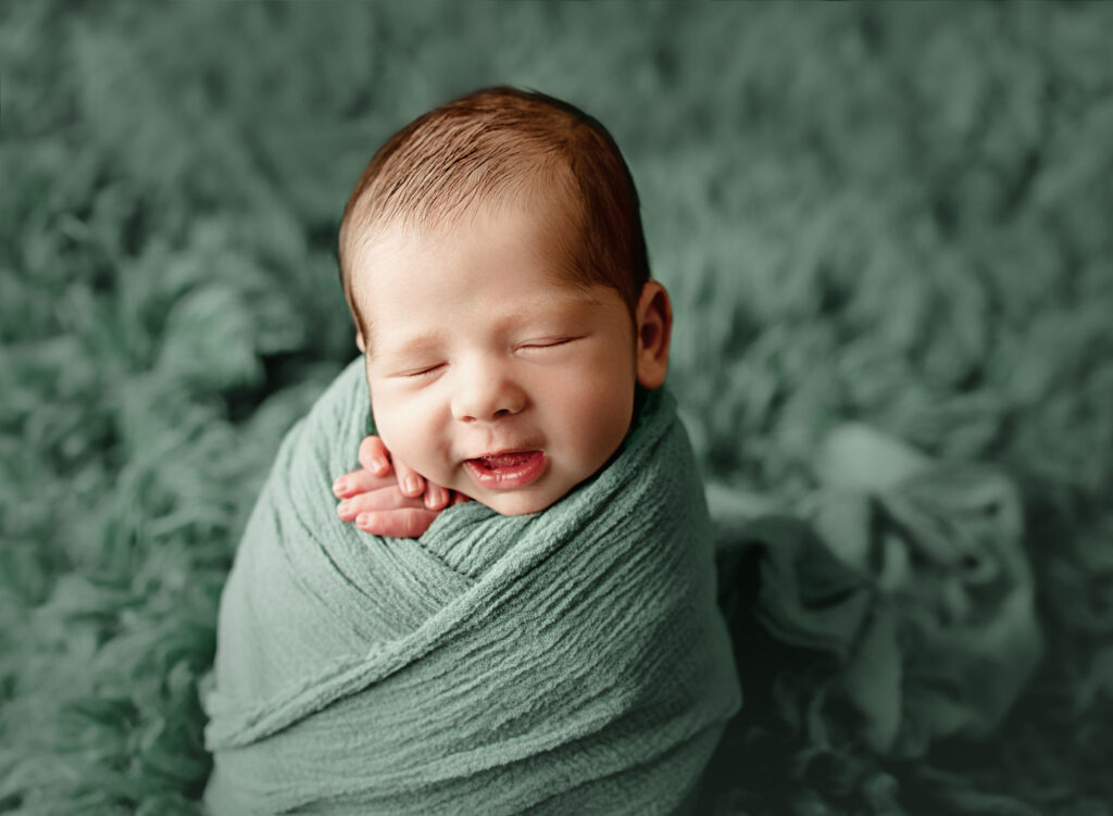 smiles during newborn photo session