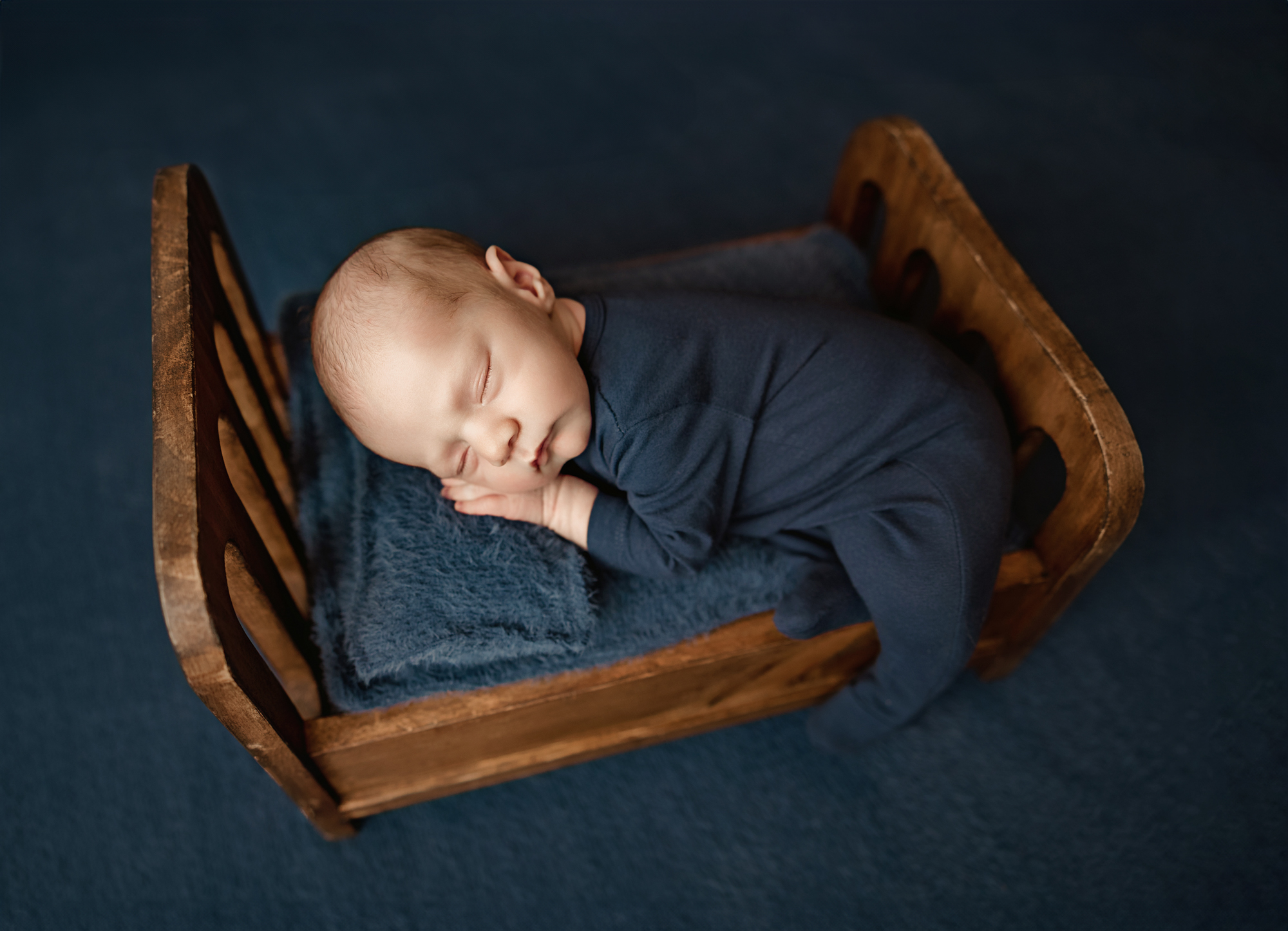 baby in baby bed newborn photo session